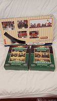 Overall lot showing Lemax train set box and two John Deere ornament boxes