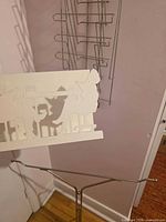 Wall rack and blanket stand together; foreground includes small white wire divider illustrating file sorter scale