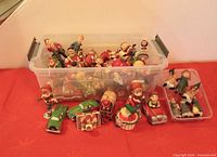 Bin filled with mixed ceramic ornaments plus several displayed in front