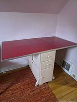 Full view of table with leaves extended showing drawers and casters