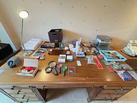 Full desk view showing lamp, engraver box, organizers, stationery
