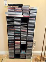Full view of black CD tower filled with CDs