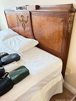 Headboard front showing veneer pattern and brass mounts