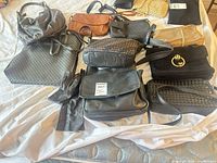 Overview of all handbags, clutches, crossbodies and gloves on bed