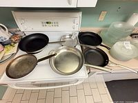 Overview of six pans on stove