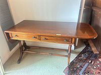 Full view of mahogany writing desk with one leaf down