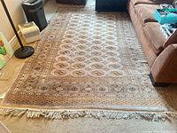 Full view of Persian wool rug on floor showing size, pattern, and fringe