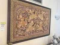 Full view of framed beaded textile wall art on wall