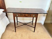 Front view of table with both leaves raised showing drawer and stretcher