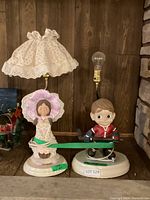 Both figurine lamps side by side showing overall design and size reference