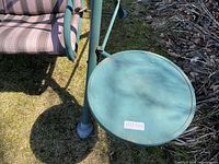 Close view of attached round side table and partial seat cushion