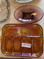 Top view of amber divided tray beside purple bowl