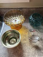 All four glass candy dishes grouped on countertop