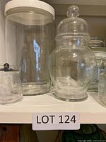 Group of clear glass containers on shelf
