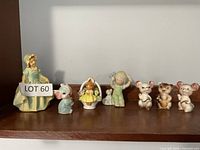 Full view of all eight ceramic figurines on shelf