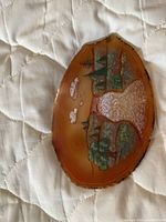 Painted agate slice with landscape scene