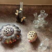 Group shot of all five floral arranging pieces