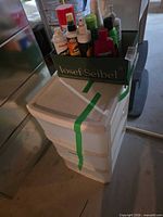 Overall lot: white 3-drawer storage unit with tray of cleaners on top