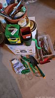 Overall lot showing tools, pots, fertilizer, gloves on floor