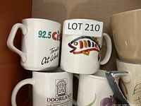 Stacked view of three promotional mugs and fish mug for graphics and logo visibility