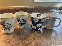 Four assorted mugs standing side by side