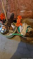 Ceramic planter, gazing ball, branches, cones, faux flowers, one bushel basket