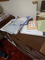 Assorted scrapbooking items spread on dresser