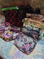 Group view of all five purses on bed