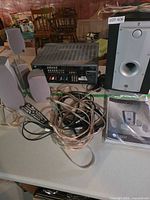 Rear view of receiver, satellites, subwoofer, remotes, wiring