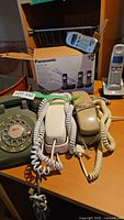 Overall group of corded rotary, push-button phones, cordless handsets, Panasonic box