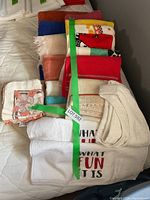 Full stack of assorted towels on bed