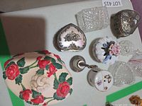 Top view showing painted wooden box, metal heart box, square crystal box, porcelain rose box, bud vase, butterfly box and glass dishes