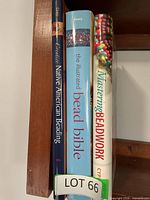 Spine view of three beadwork books on shelf