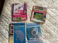 All four craft books laid out on quilted surface