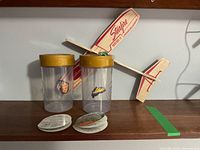 Two My Magic Butterfly jars, balsa wood glider displayed behind