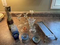 Full group of candle holders, candles and tray displayed on countertop