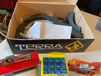 Box labeled Terra with track pieces and accessory parts visible