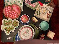 All Christmas serveware, plates, trays, bowls, linens laid out on table