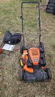 Top view of Columbia mower with bag, manual and gas can
