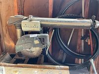 Full view of Craftsman radial arm table saw on wooden base with blade and guard