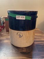 Front view of two-tone stoneware crock showing capacity mark