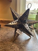 Full view of metal star lantern on countertop