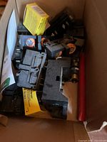 Overview of box contents showing fuse holders, fuses, Bussmann packaging and red rod