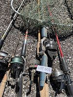 All rods, reels and landing net laid on ground