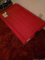 Top view of red flat storage tote with lid closed