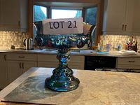 Front view of blue iridescent pedestal candy dish
