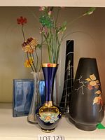Group of five visible vases on shelf