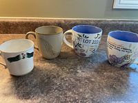 All four mugs side by side on countertop
