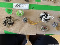 Overview showing two spiral pendants, beaded sphere and three chainmaille stars