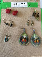 All six pairs of earrings laid out on surface